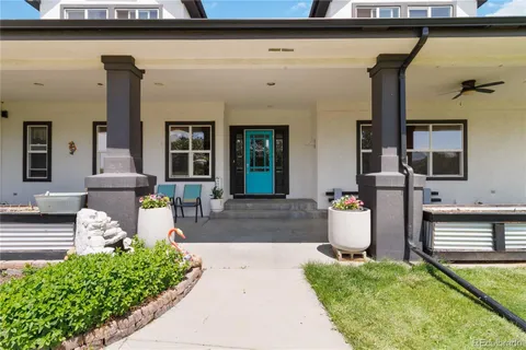 a front view of a house with outdoor seating