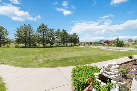 a view of a golf course with chairs
