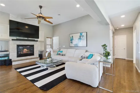 a living room with furniture fireplace and flat screen tv