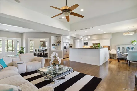 a living room with furniture and kitchen view
