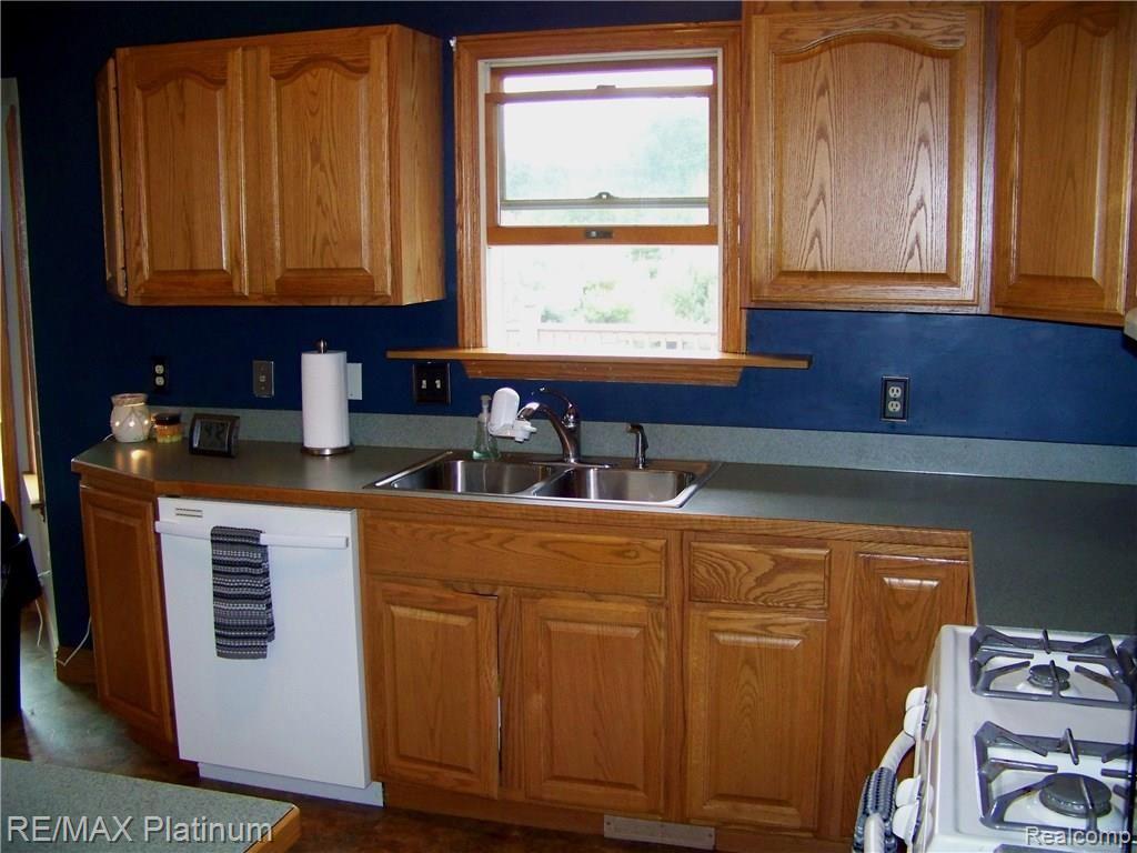 198 West Coon Lake Road Howell, MI 48843 - Photo 7 of 22 Kitchen window overlooks deck and yard. Stainless sink.