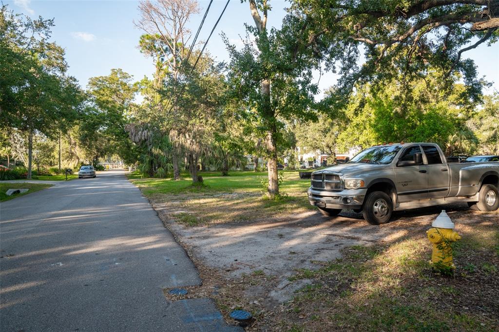 6027 98th Way North St. Petersburg, FL 33708 - Photo 9 of 20 a view of a yard with cars parked