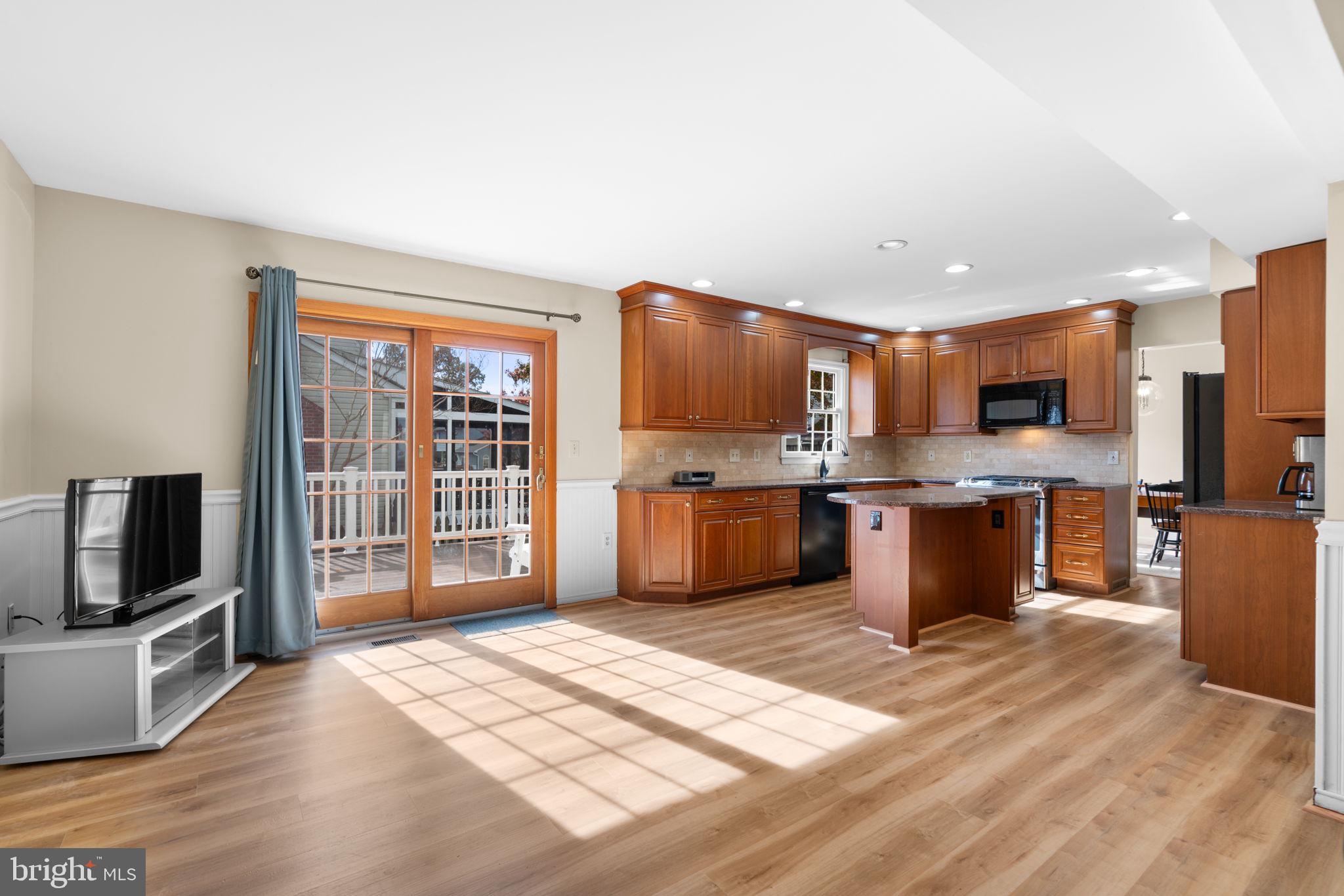 103 Idlewild Road Severna Park, MD 21146 - Photo 15 of 39 a large kitchen with stainless steel appliances kitchen island granite countertop a large counter top space a sink stainless steel appliances and cabinets