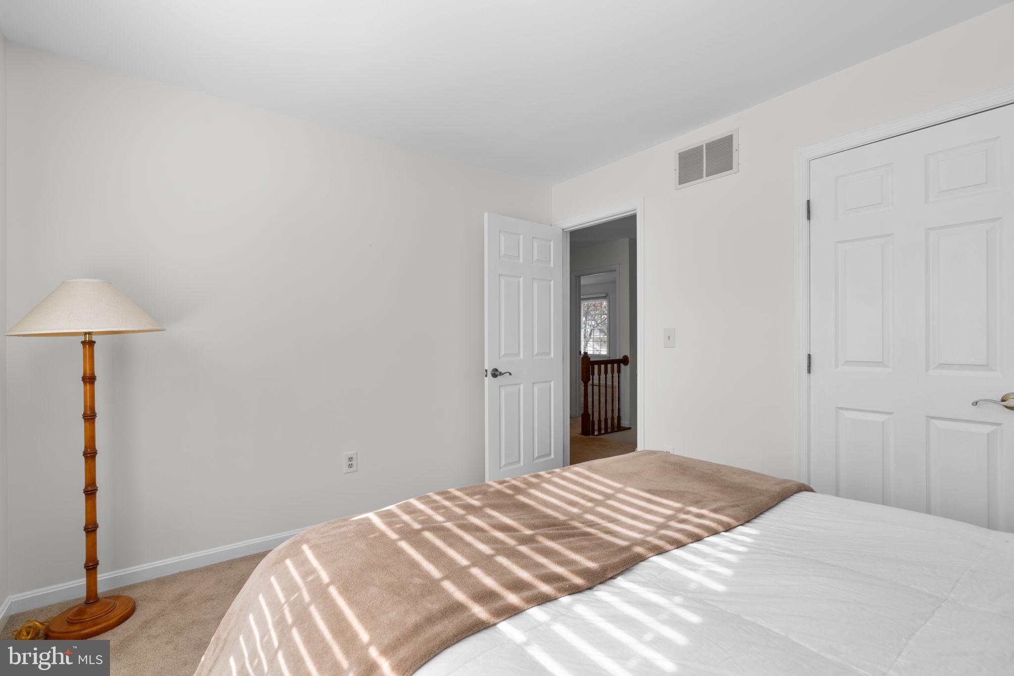 103 Idlewild Road Severna Park, MD 21146 - Photo 25 of 39 a bedroom with a bed and a lamp