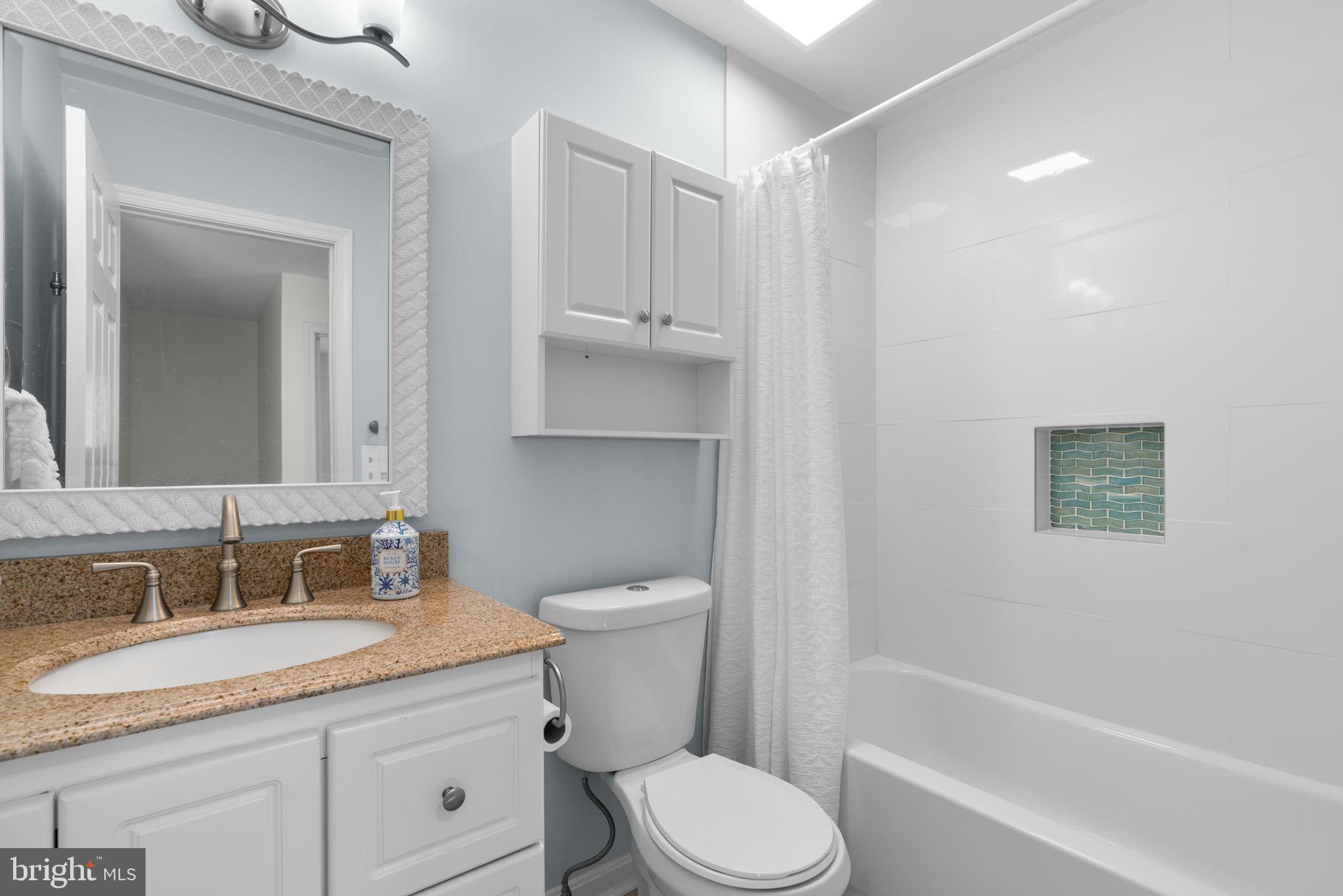 103 Idlewild Road Severna Park, MD 21146 - Photo 28 of 39 a bathroom with a granite countertop toilet a sink and bathtub