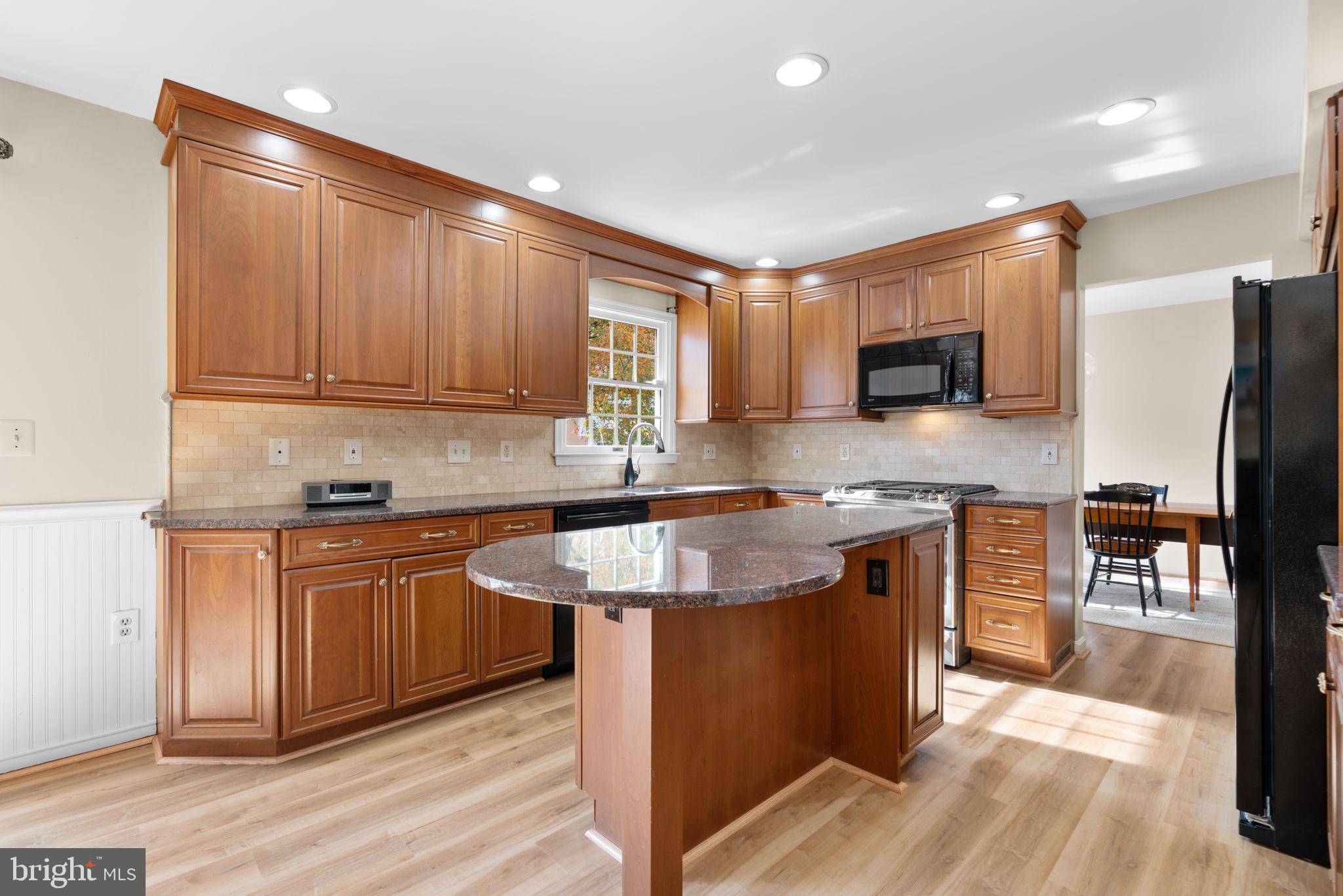 103 Idlewild Road Severna Park, MD 21146 - Photo 9 of 39 a kitchen with stainless steel appliances granite countertop a sink stove microwave and refrigerator