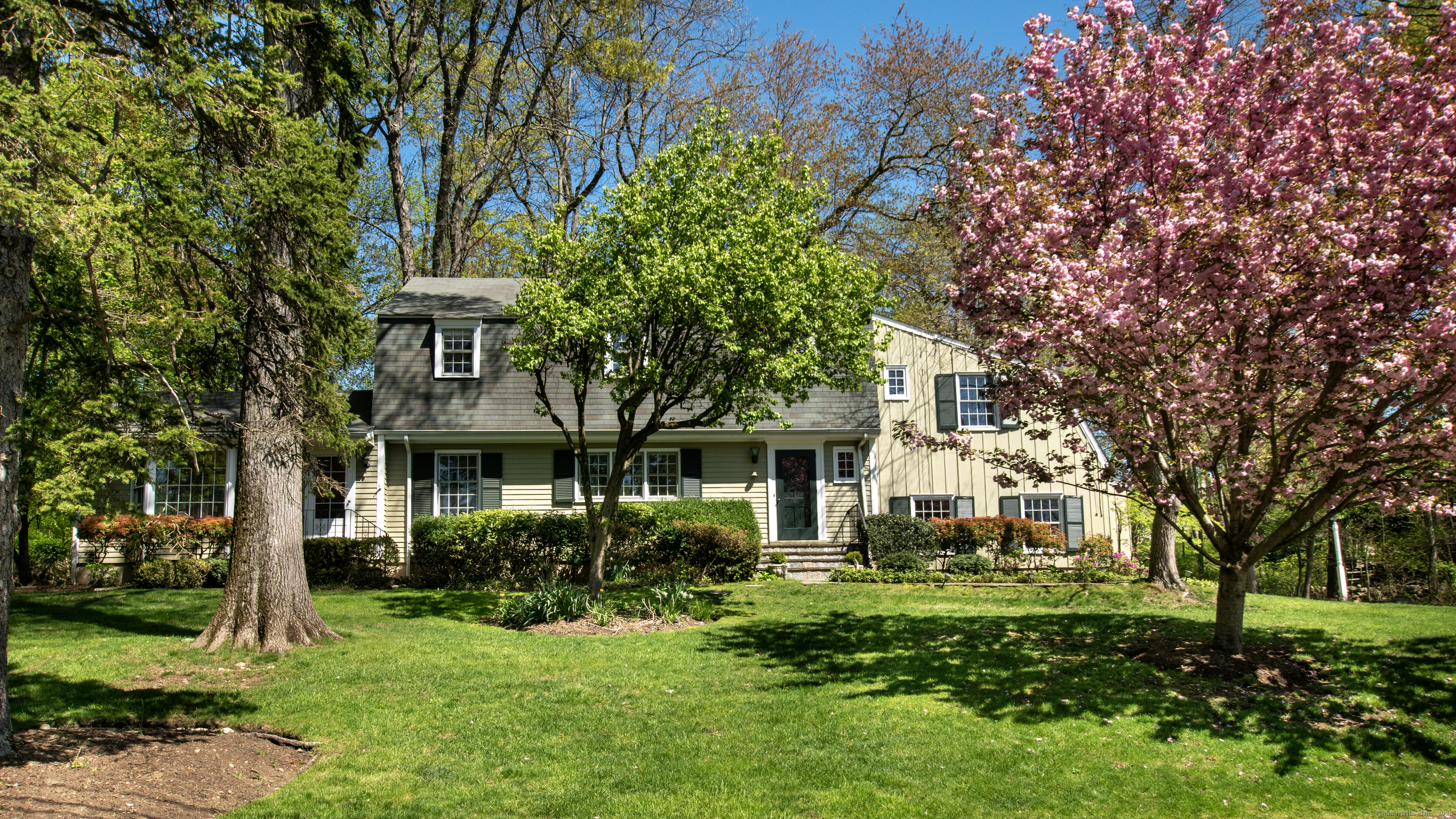 a front view of a house with a garden