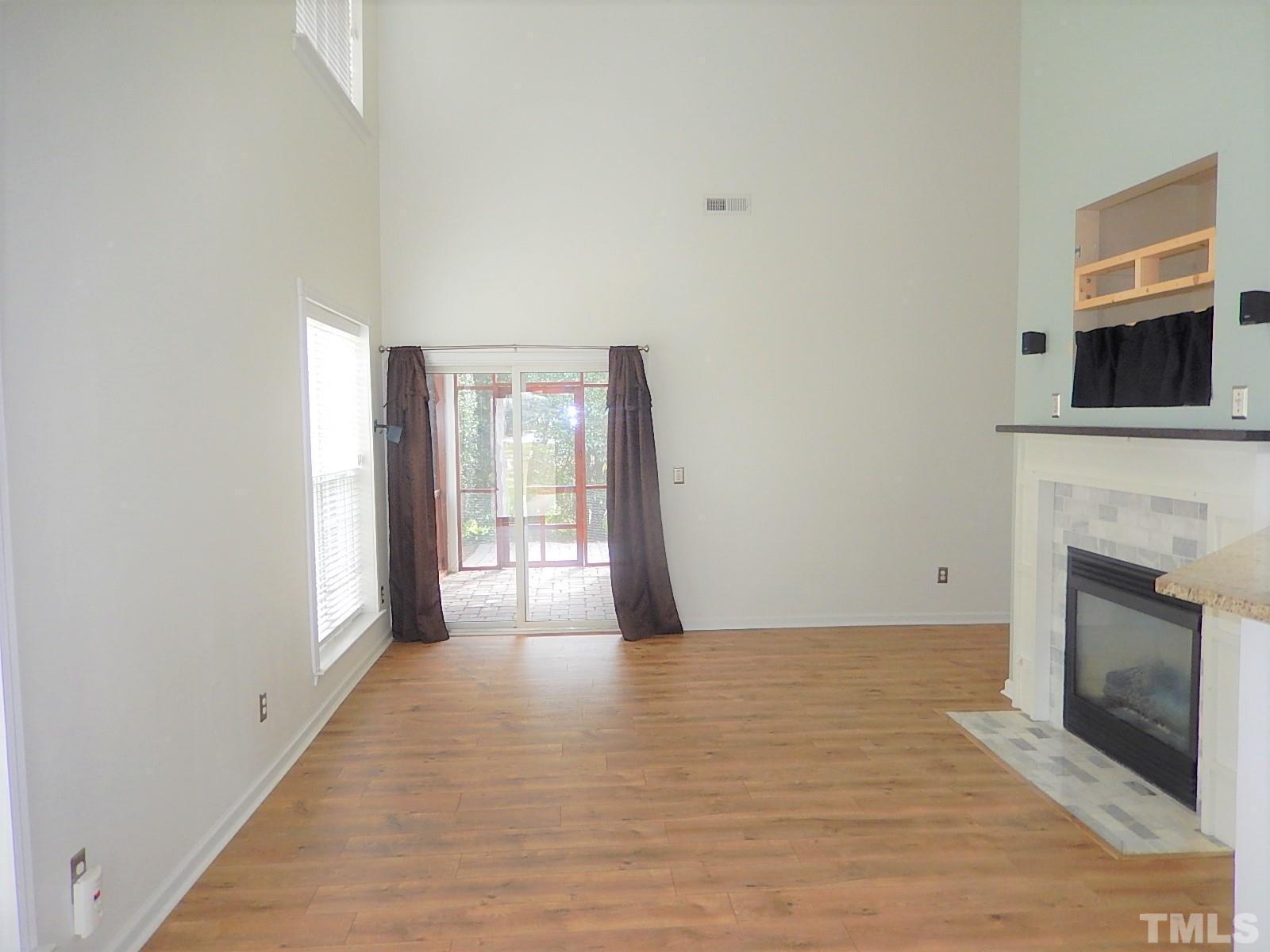 4717 Delta Ridge Court Raleigh, NC 27612 - Photo 3 of 30 a view of an empty room with a fireplace and a window