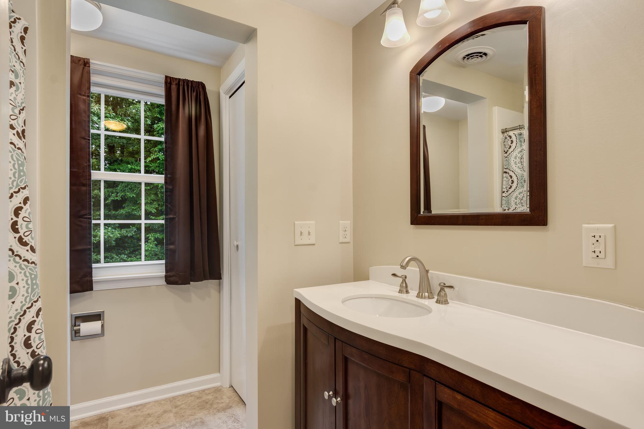 5 Reed Court Chestertown, MD 21620 - Photo 18 of 27 a bathroom with a sink vanity and a mirror