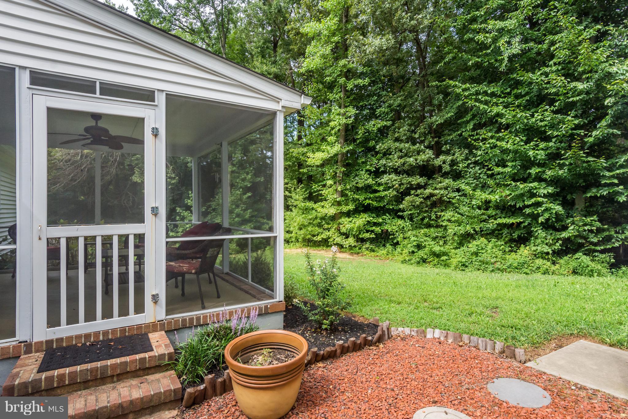 5 Reed Court Chestertown, MD 21620 - Photo 21 of 27 a view of a patio with table and chairs potted plants with wooden floor and fence