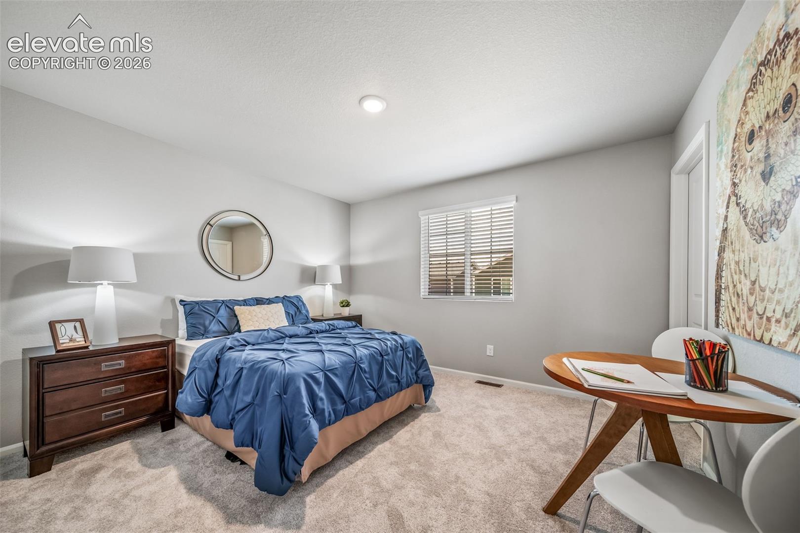 4866 Truscott Road Colorado Springs, CO 80925 - Photo 3 of 20 Carpeted bedroom featuring light gray walls, a single window with blinds, and a built-in ceiling light fixture
*Photos of a model home*