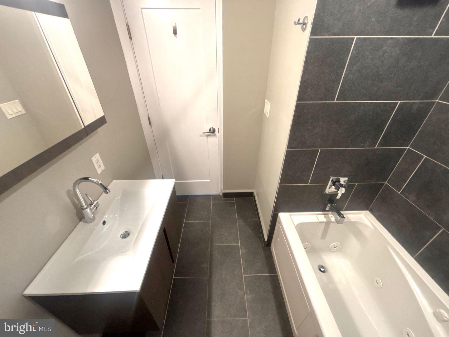 533 Manton Street Philadelphia, PA 19147 - Photo 14 of 22 a bathroom with a sink and mirror