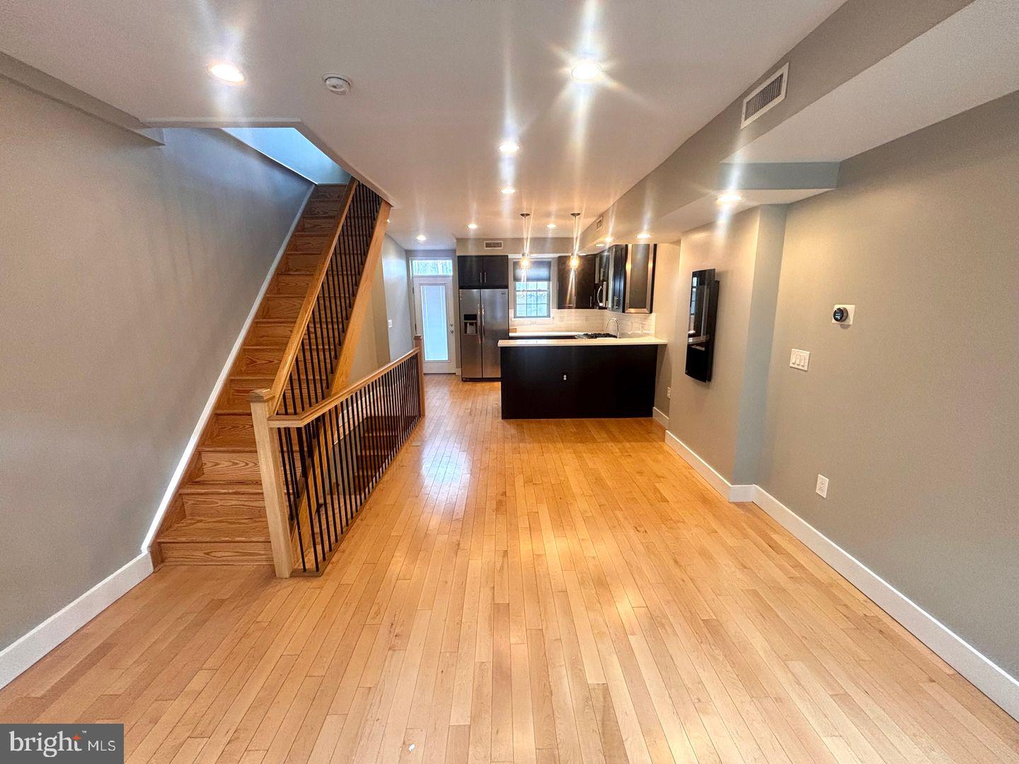 533 Manton Street Philadelphia, PA 19147 - Photo 3 of 22 a view of entryway and kitchen with wooden floor