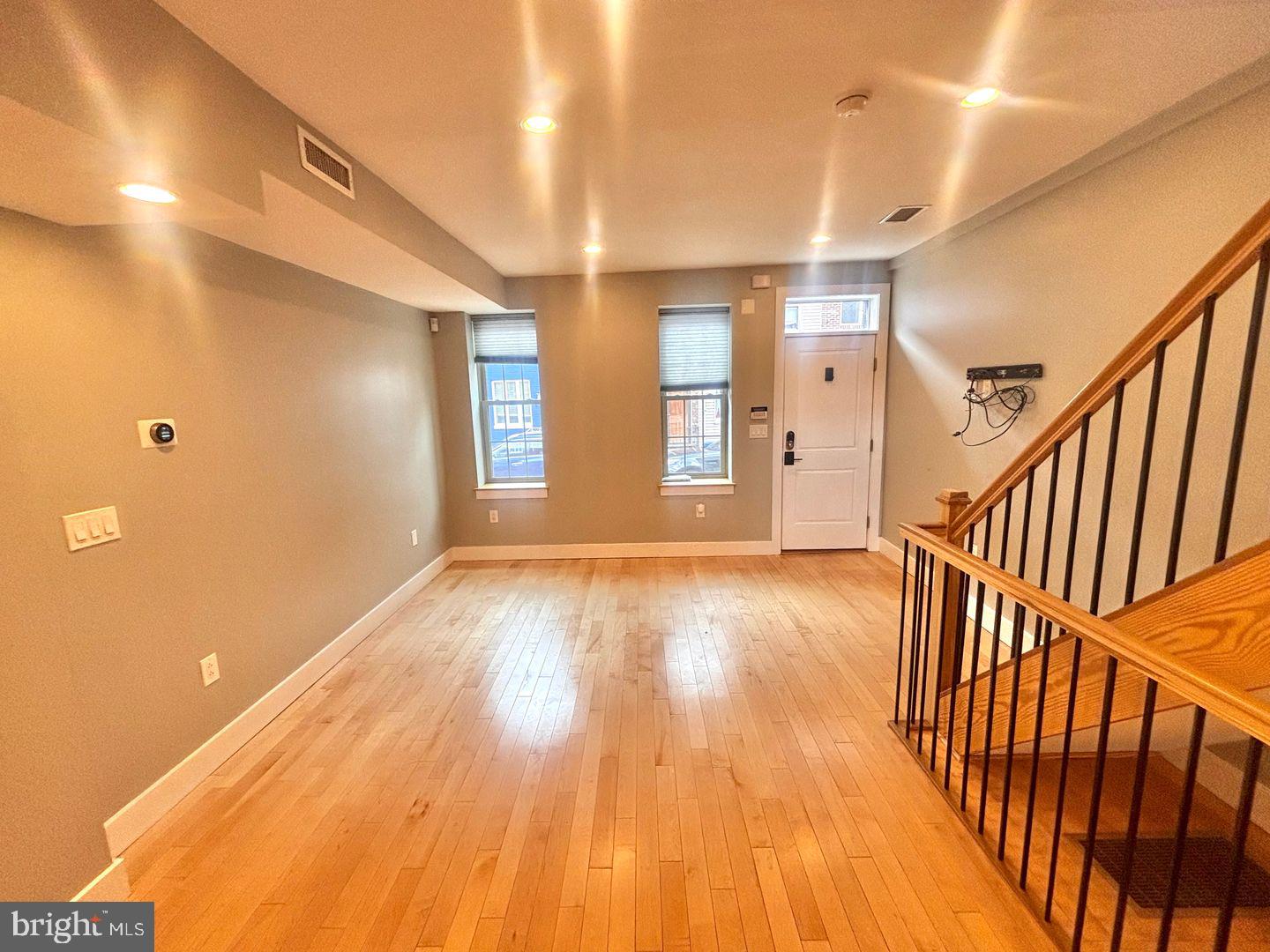 533 Manton Street Philadelphia, PA 19147 - Photo 4 of 22 a view of an empty room with stairs and a window