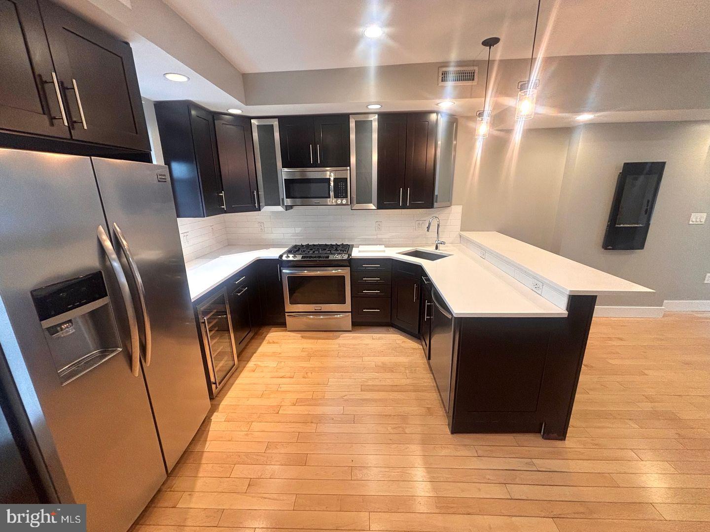 533 Manton Street Philadelphia, PA 19147 - Photo 7 of 22 a large kitchen with stainless steel appliances kitchen island granite countertop a sink a stove and refrigerator