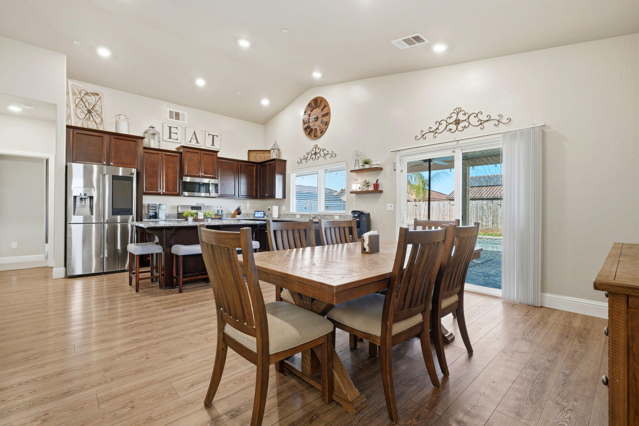 756 Strada Street Lemoore, CA 93245 - Photo 19 of 53 a view of a dining room with furniture and wooden floor