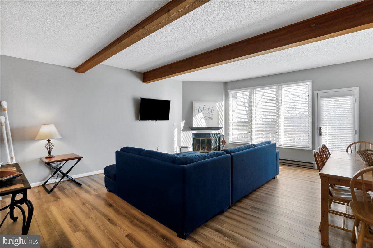 76 Bright Passage McHenry, MD 21541 - Photo 2 of 63 a living room with couches and a flat screen tv with kitchen view
