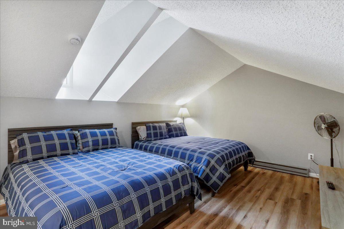 76 Bright Passage McHenry, MD 21541 - Photo 25 of 63 a bedroom with two beds and wooden floor