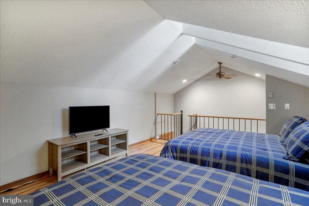 76 Bright Passage McHenry, MD 21541 - Photo 27 of 63 a bedroom with furniture and a flat screen tv