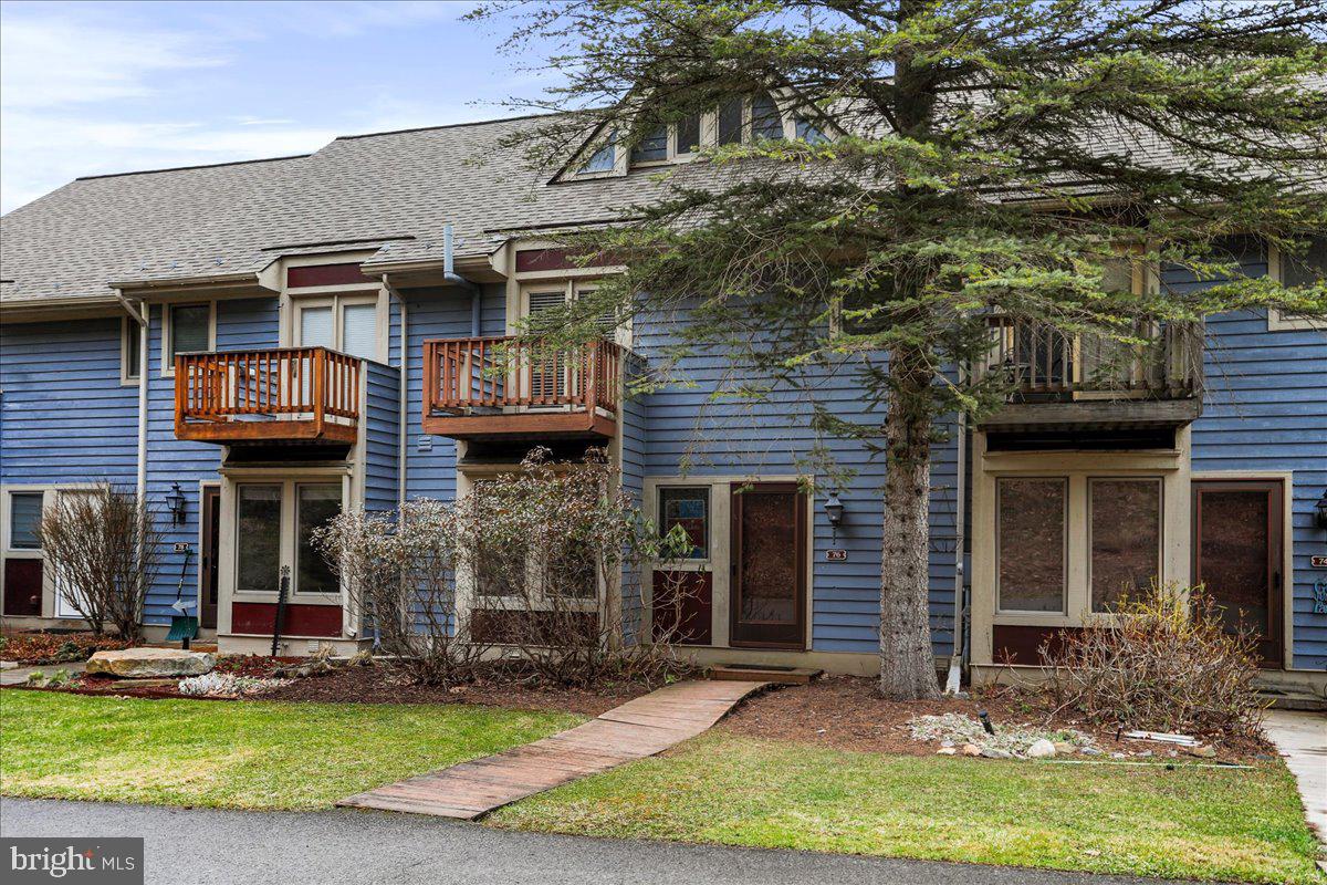 76 Bright Passage McHenry, MD 21541 - Photo 38 of 63 a front view of a house with a yard and garage
