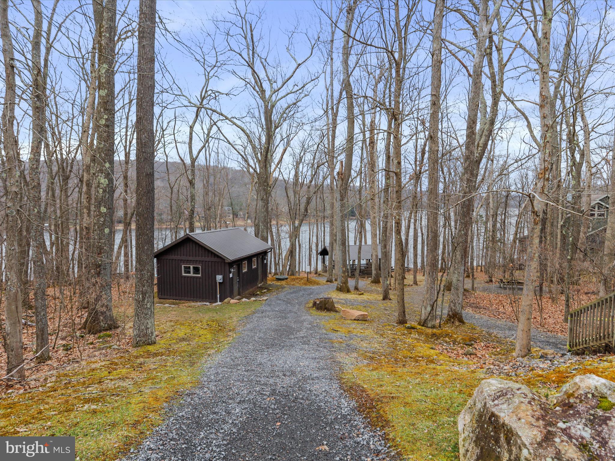 76 Bright Passage McHenry, MD 21541 - Photo 54 of 63 a view of a backyard with large tree and wooden fence