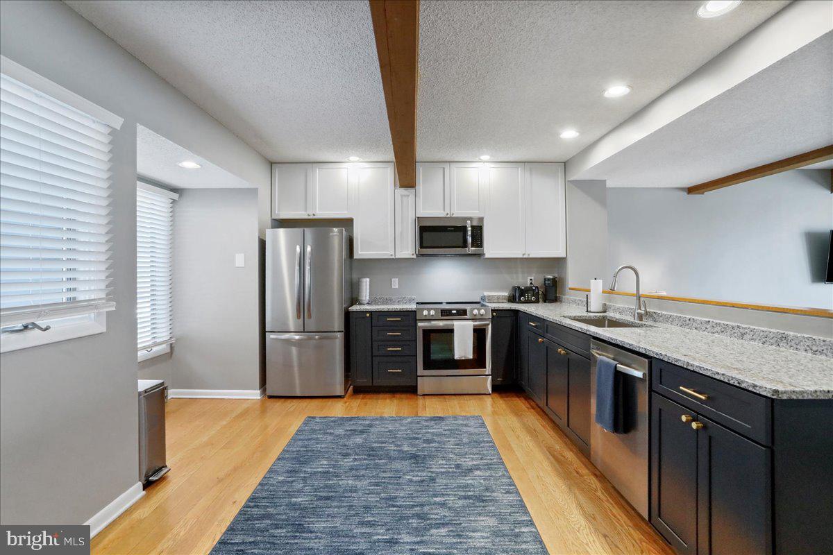 76 Bright Passage McHenry, MD 21541 - Photo 7 of 63 a large kitchen with stainless steel appliances granite countertop a stove a sink dishwasher and a refrigerator