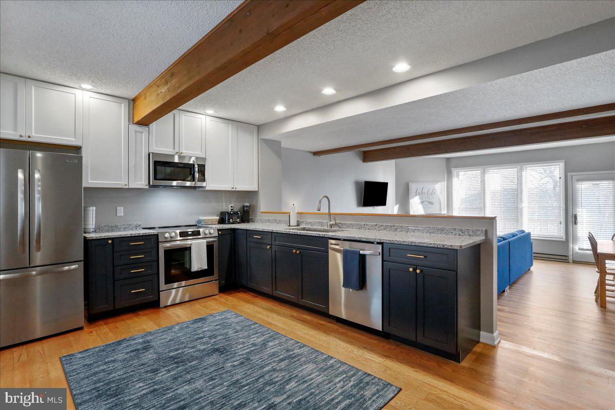 76 Bright Passage McHenry, MD 21541 - Photo 8 of 63 a kitchen with stainless steel appliances granite countertop a stove top oven and refrigerator