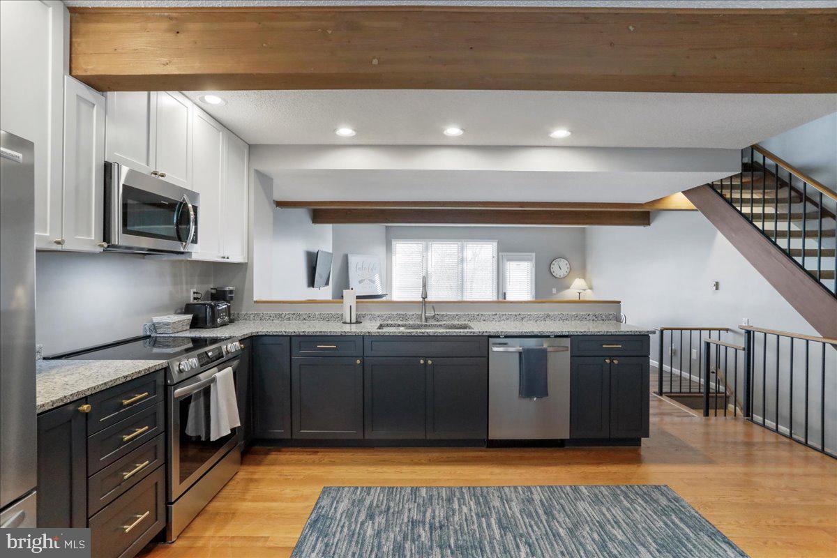 76 Bright Passage McHenry, MD 21541 - Photo 9 of 63 a kitchen with stainless steel appliances granite countertop a stove a sink and a microwave