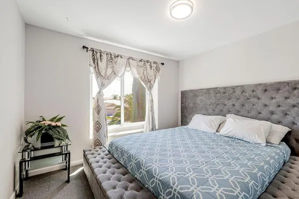 a bedroom with a bed and a window