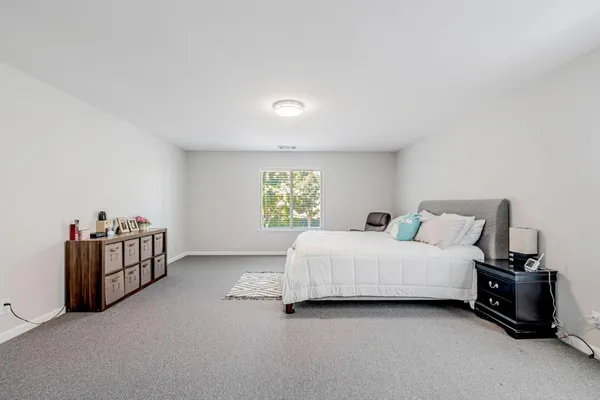 a bed room with a bed and a window