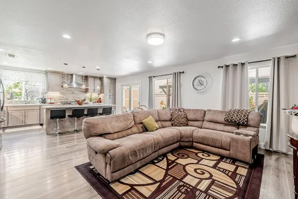 a living room with furniture and wooden floor