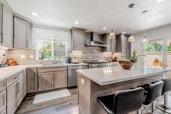 a kitchen with a sink stove and cabinets