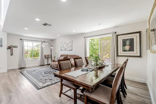 a view of a dining room with furniture window and wooden floor