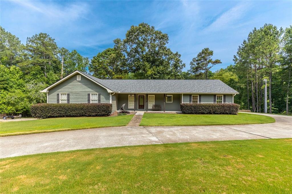 879 James Powers Road Monroe, GA 30656 - Photo 1 of 1 a front view of a house with a yard and trees