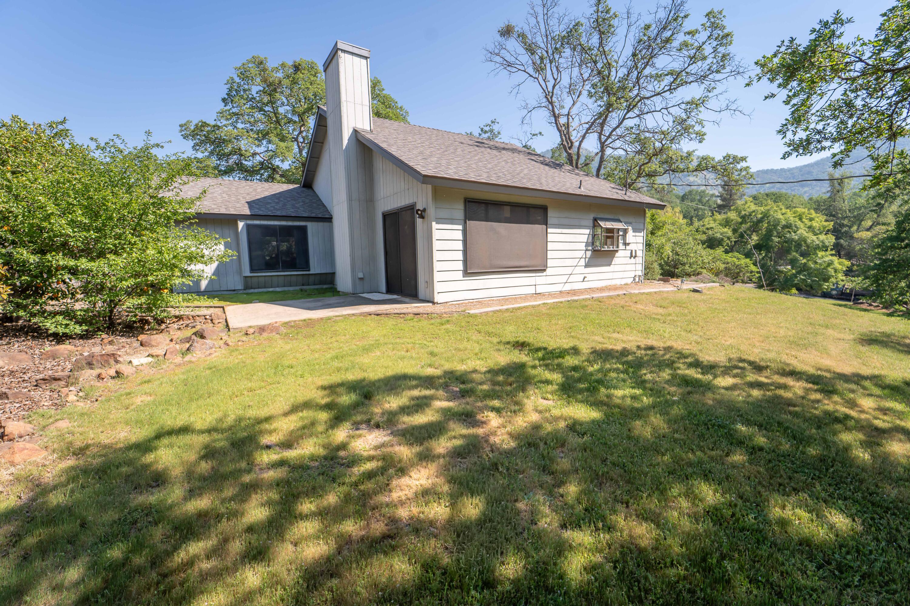 40962 Oak Ridge Drive Three Rivers, CA 93271 - Photo 28 of 36 a front view of house with yard and trees