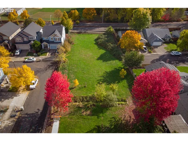 a view of a house with a yard and a pool