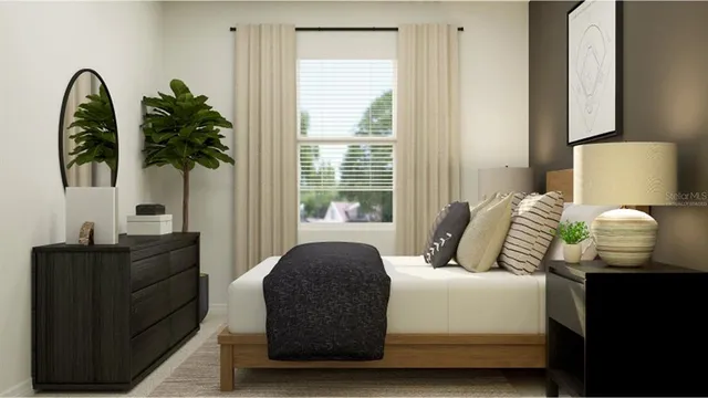 a bedroom with a bed and a potted plant