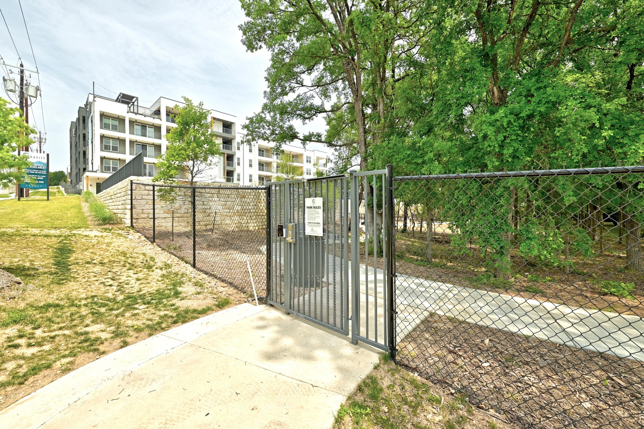 4801 Springdale Road, Unit 2301 Austin, TX 78723 - Photo 33 of 36 Secure community access features a private entry gate and fenced green spaces.