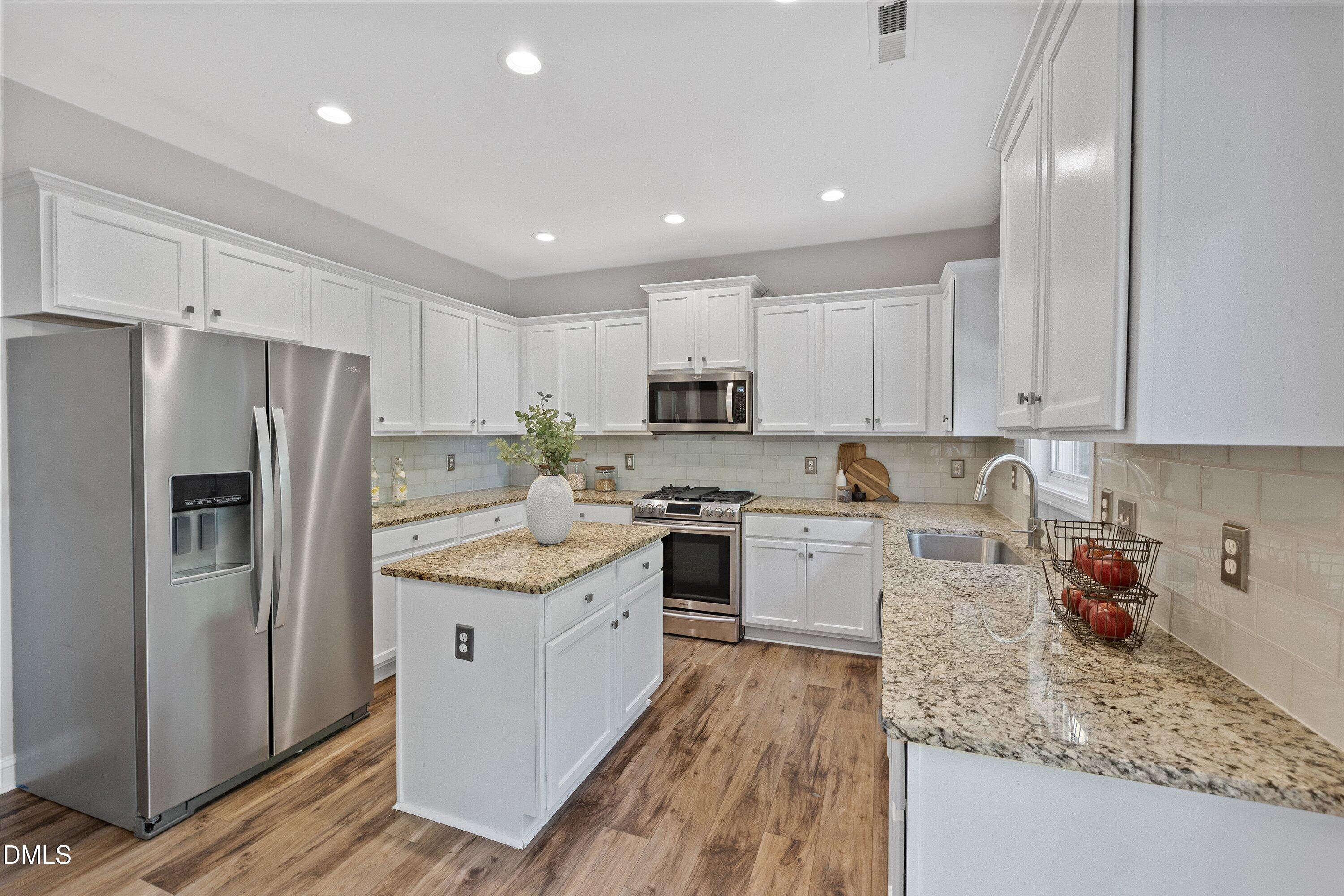 3717 Windmeade Road Wake Forest, NC 27587 - Photo 21 of 51 a kitchen with a sink a refrigerator and cabinets