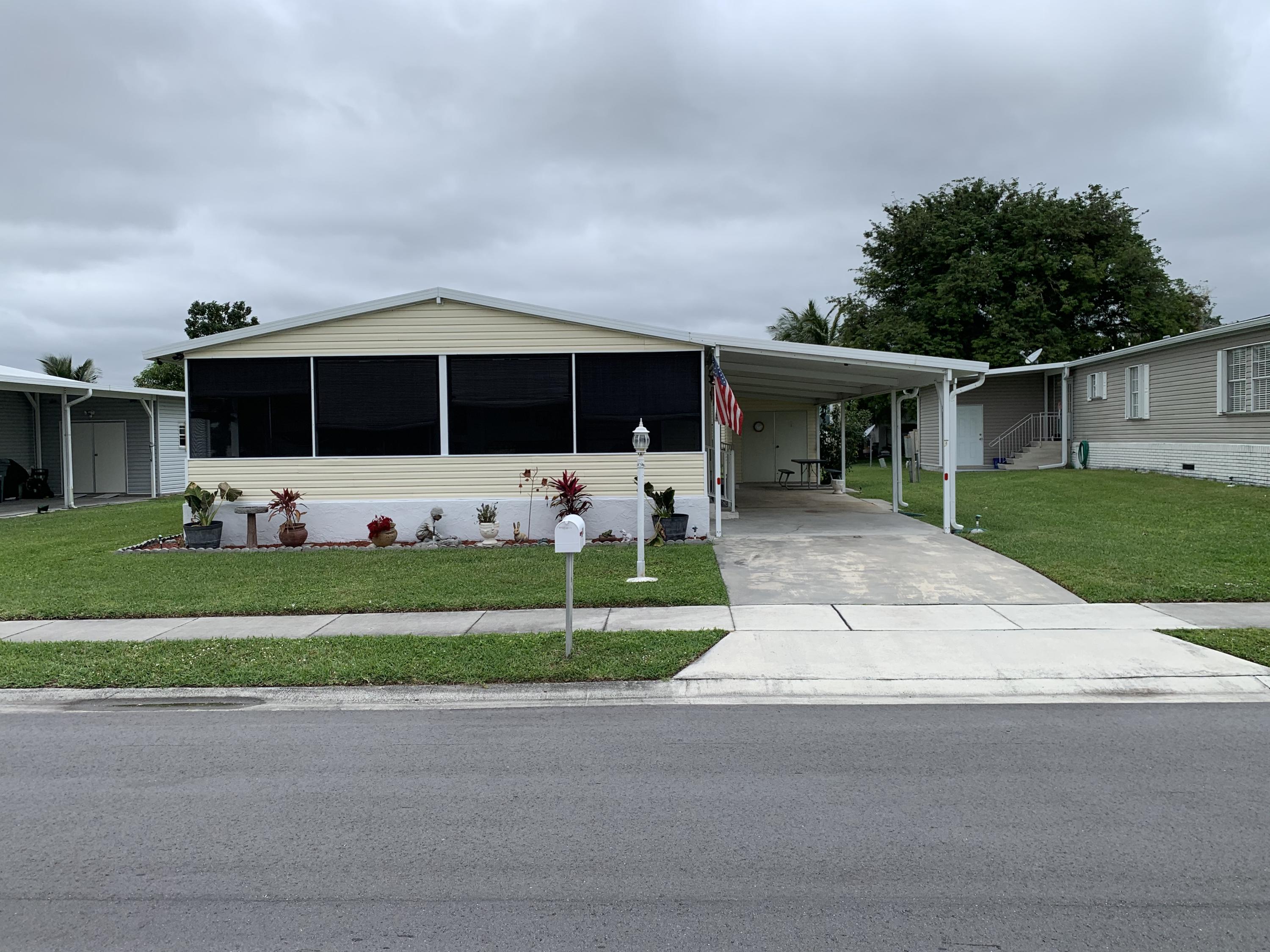 1531 Southwest 65th Avenue Boca Raton, FL 33428 - Photo 1 of 25 a front view of house with yard and green space