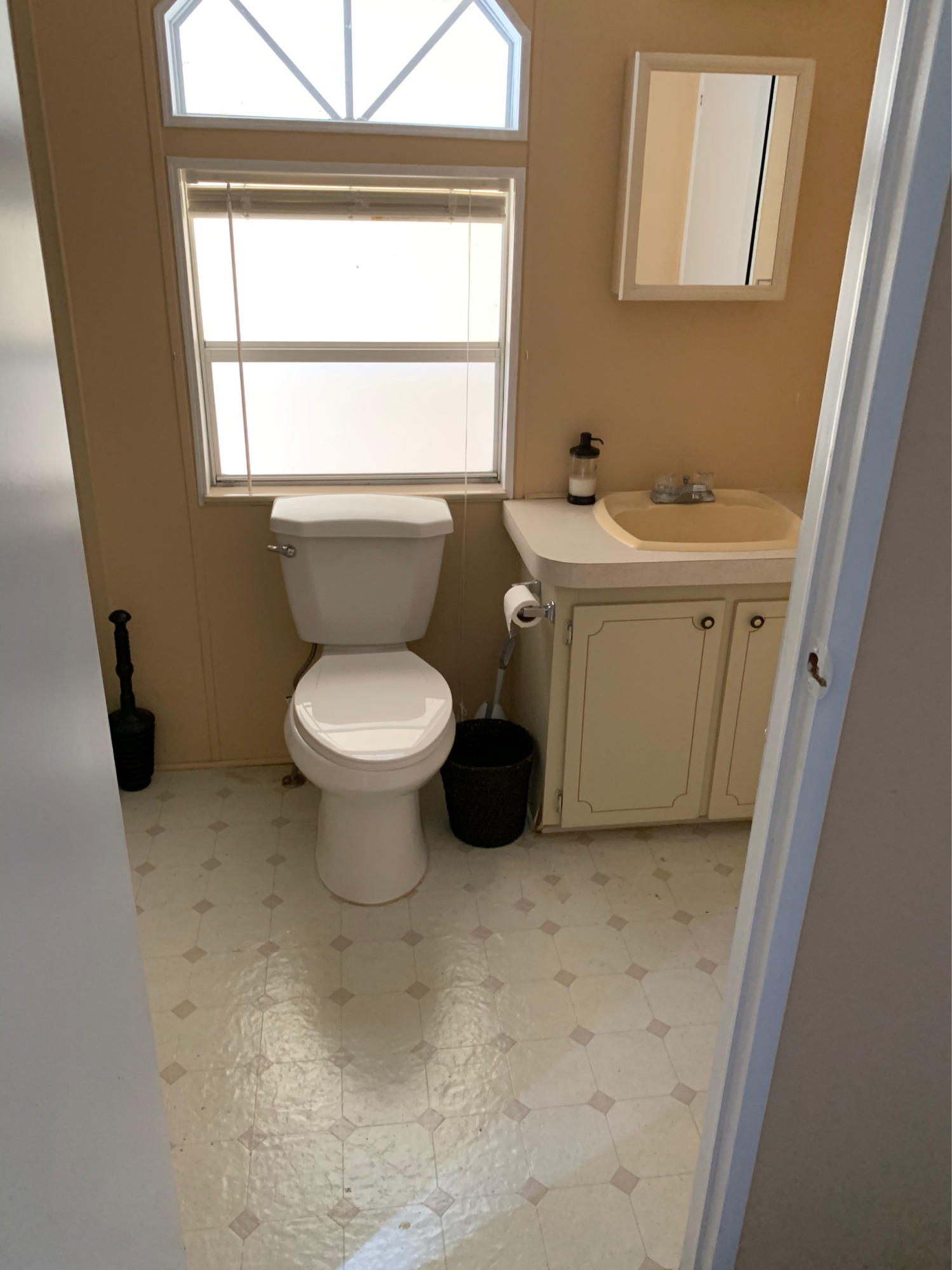 1531 Southwest 65th Avenue Boca Raton, FL 33428 - Photo 15 of 25 a bathroom with a toilet sink and window