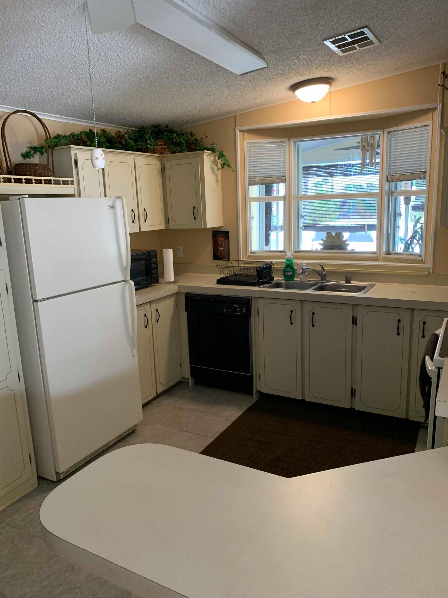 1531 Southwest 65th Avenue Boca Raton, FL 33428 - Photo 19 of 25 a kitchen with a sink a refrigerator and window