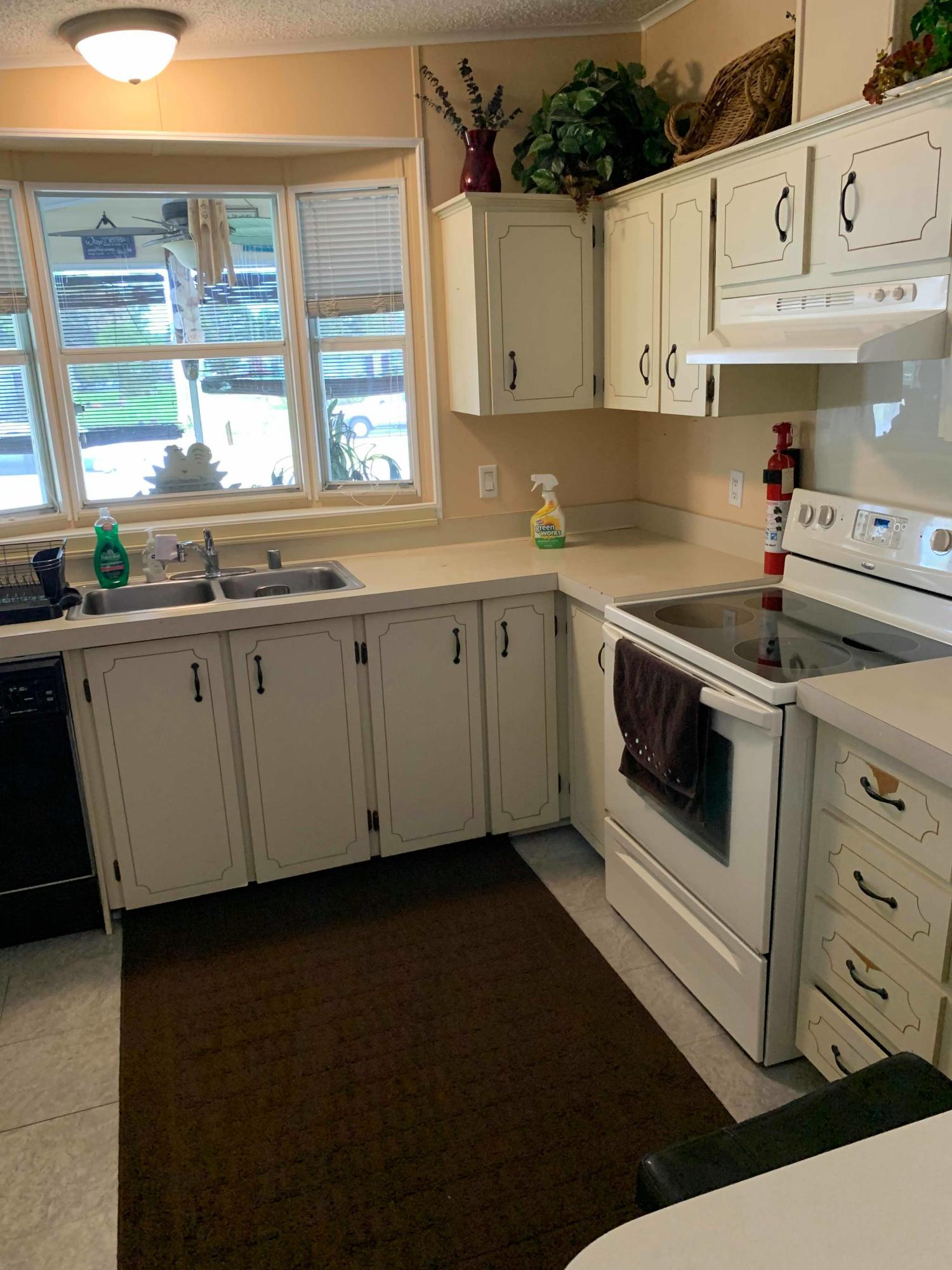1531 Southwest 65th Avenue Boca Raton, FL 33428 - Photo 20 of 25 a kitchen with granite countertop white cabinets and white appliances