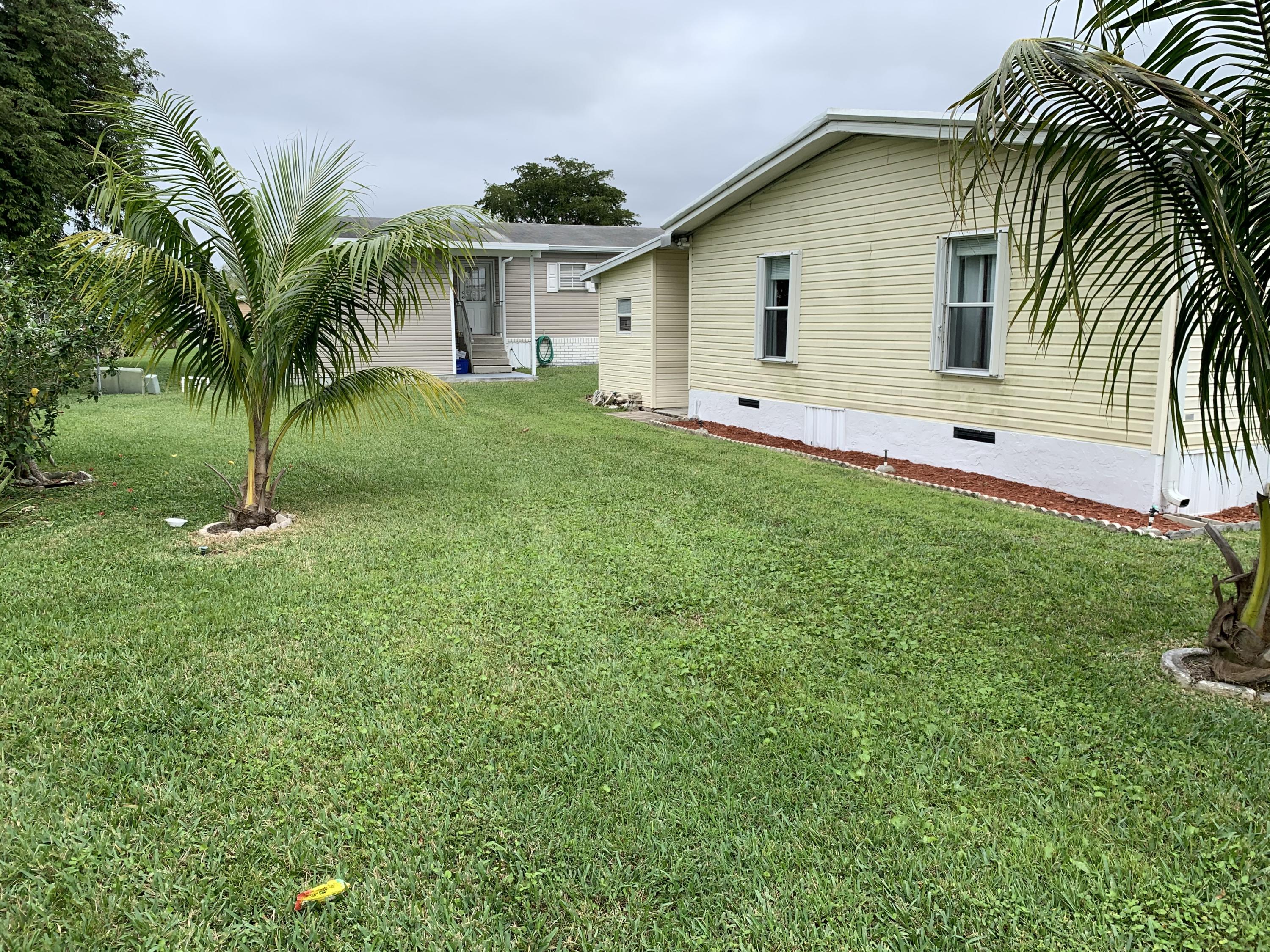 1531 Southwest 65th Avenue Boca Raton, FL 33428 - Photo 4 of 25 a view of a backyard with a plants and palm trees