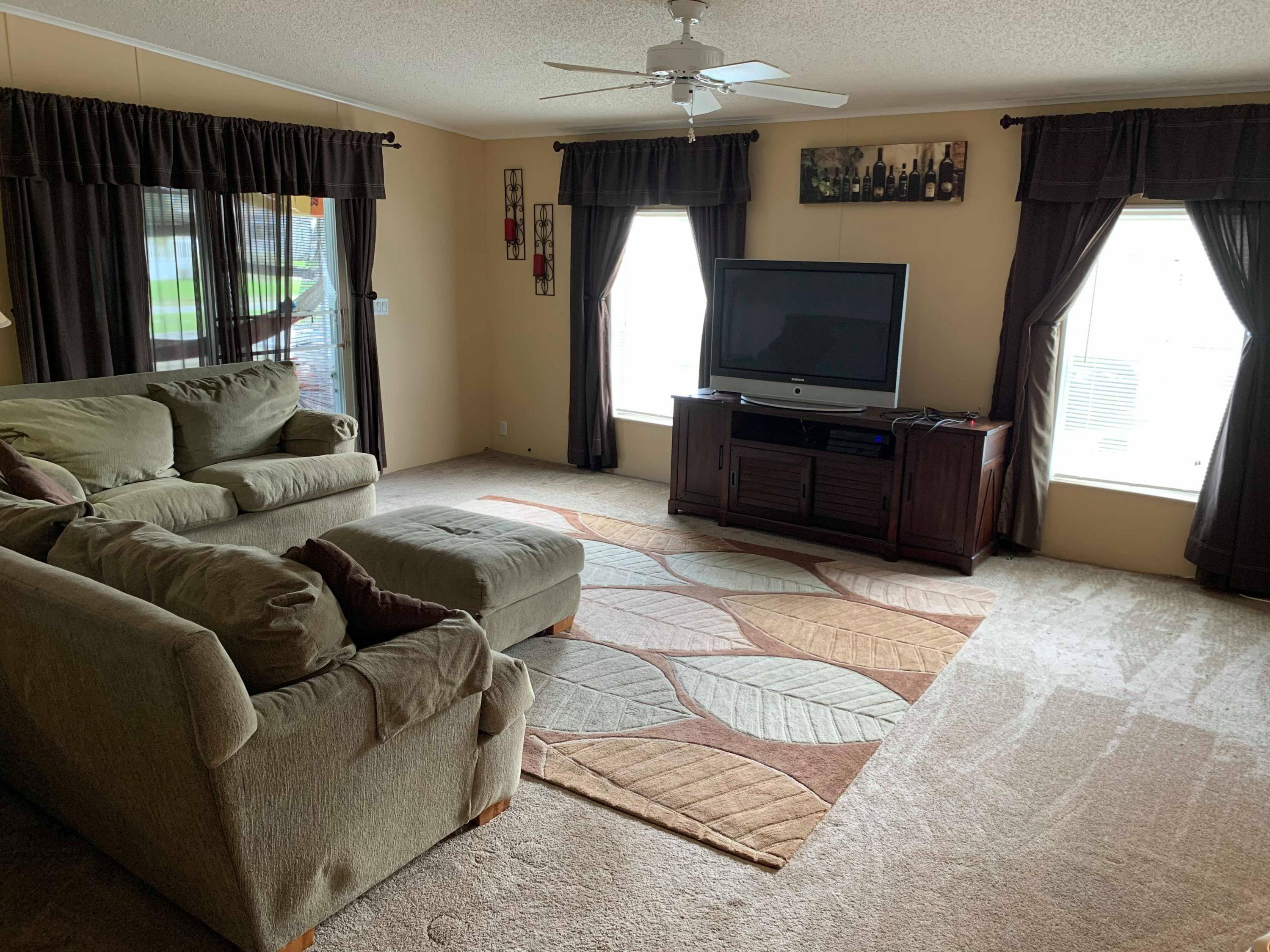 1531 Southwest 65th Avenue Boca Raton, FL 33428 - Photo 5 of 25 a living room with furniture and a flat screen tv