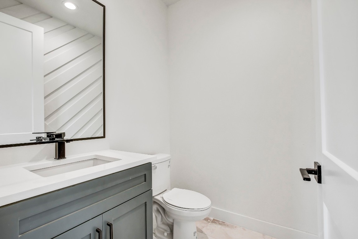 4127 East 12th Street, Unit 3 Austin, TX 78721 - Photo 11 of 29 a bathroom with a sink a toilet and mirror