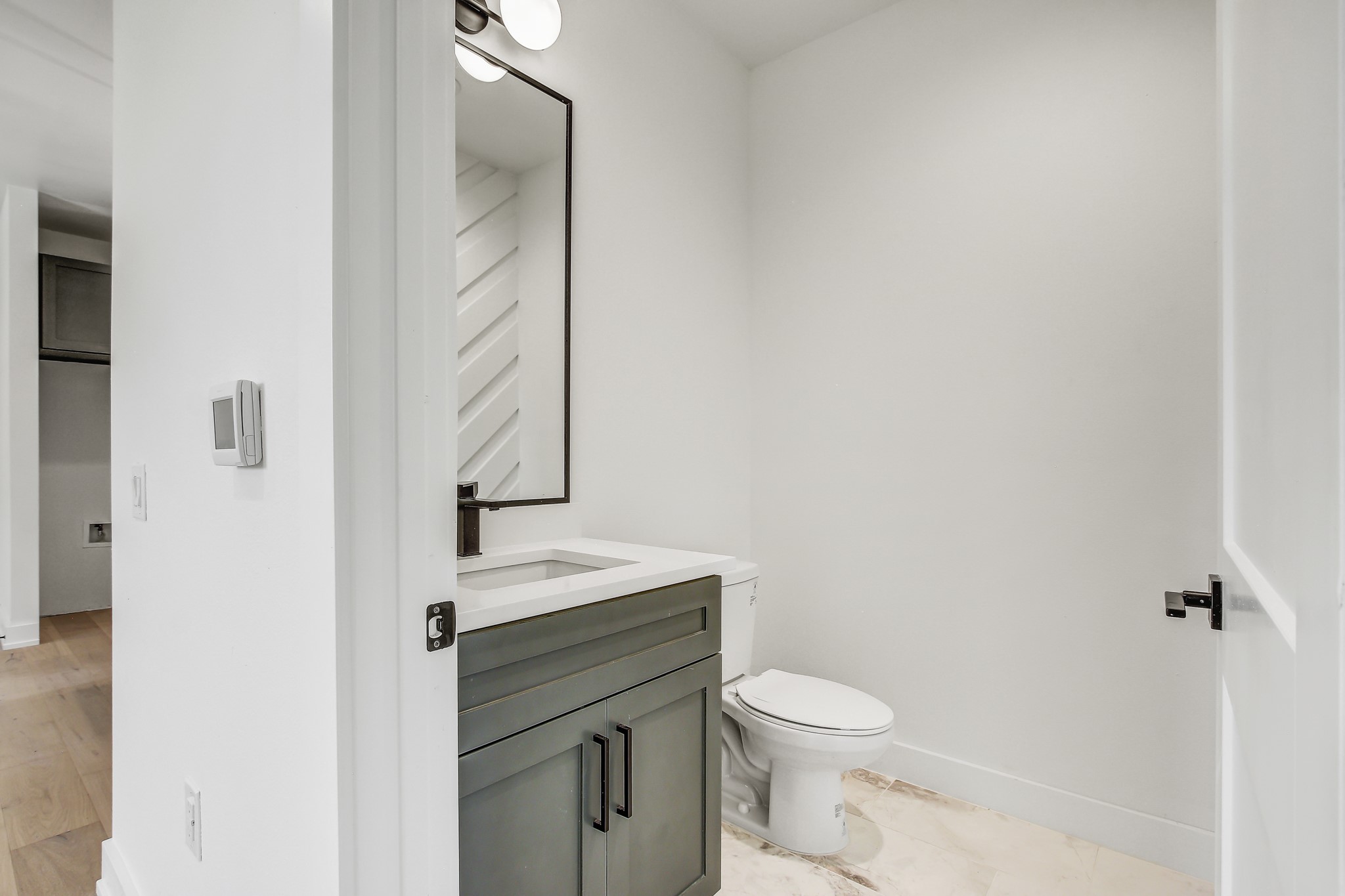 4127 East 12th Street, Unit 3 Austin, TX 78721 - Photo 12 of 29 a bathroom with a toilet a sink and mirror