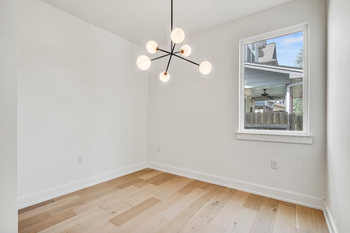 4127 East 12th Street, Unit 3 Austin, TX 78721 - Photo 13 of 29 a view of an empty room with window and wooden floor
