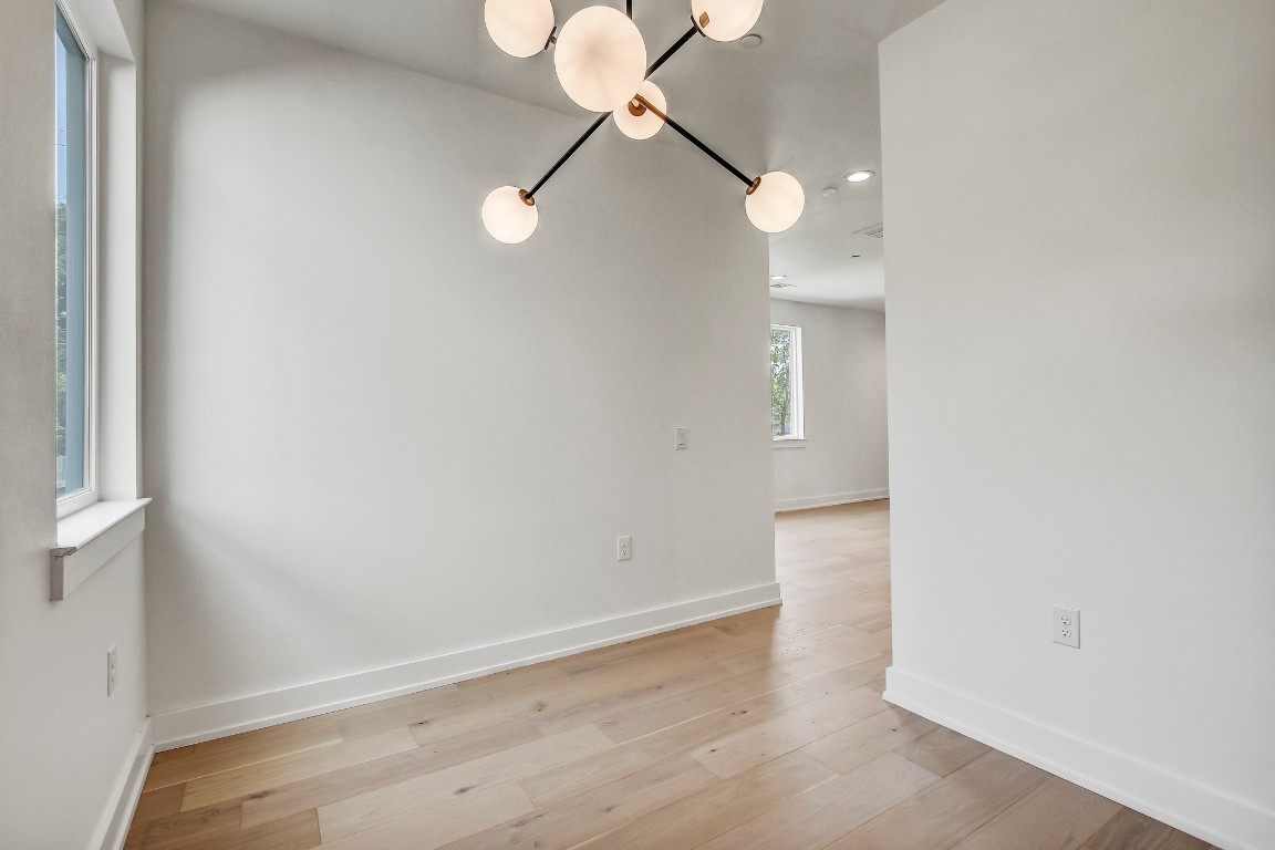 4127 East 12th Street, Unit 3 Austin, TX 78721 - Photo 14 of 29 wooden floor in an empty room with a window