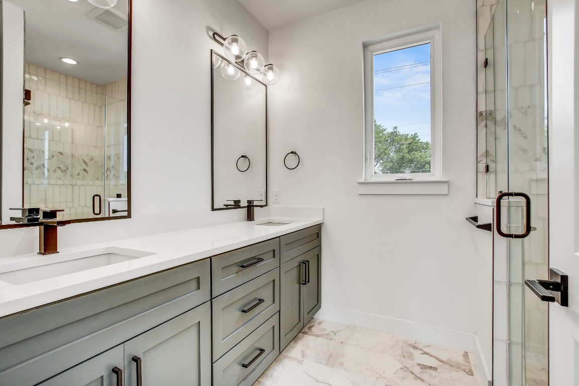 4127 East 12th Street, Unit 3 Austin, TX 78721 - Photo 4 of 29 a bathroom with a double vanity sink toilet and shower